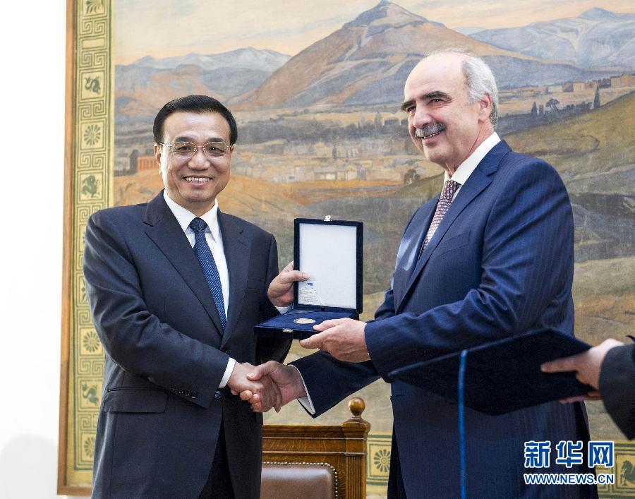 6月19日，國務(wù)院總理李克強在希臘議會大廈會見希臘議長米馬拉基斯。這是會見前，米馬拉基斯代表希臘議會向李克強授予議會金質(zhì)勛章。新華社記者 王曄 攝